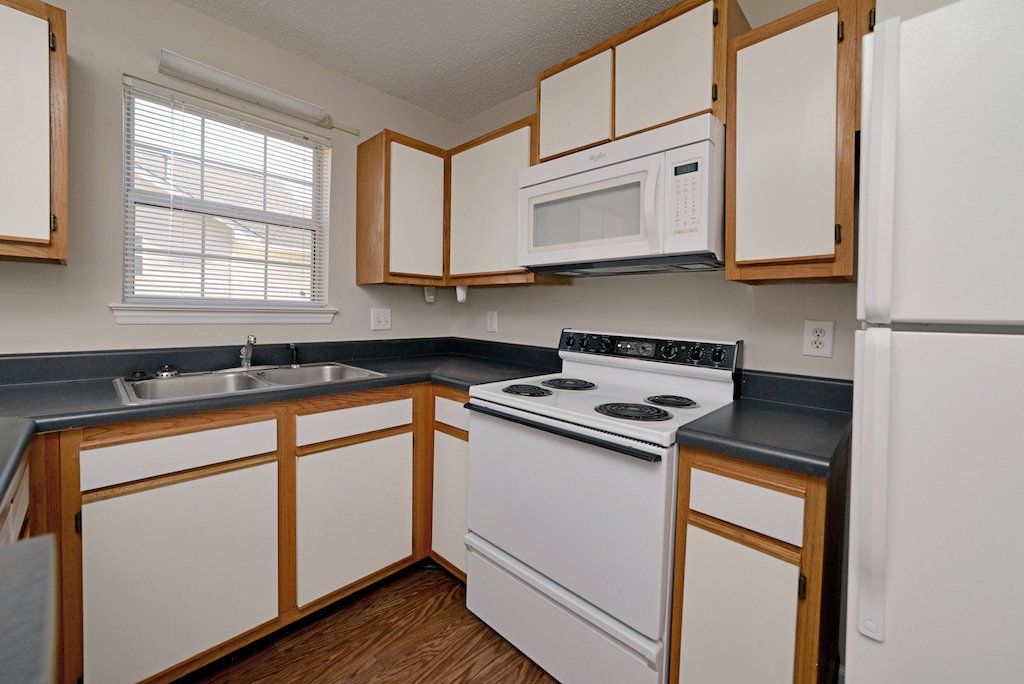summits kitchen 2-toned cabinet with white stove and white fridge