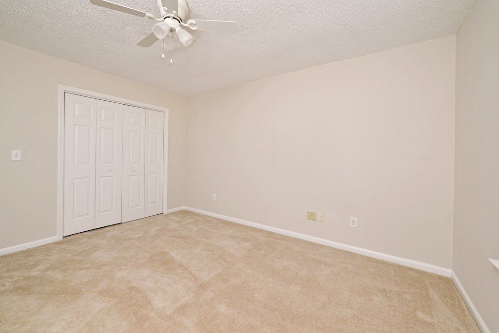 Summits guest bedroom- view with guest closet door from corner