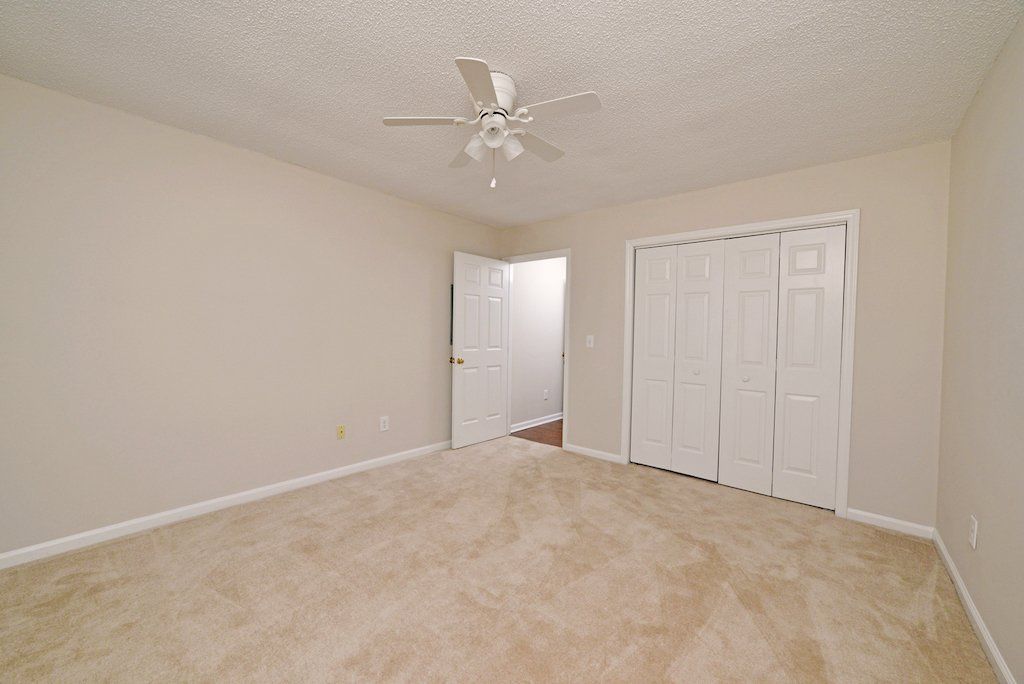 Summits guest bedroom- view with guest closet door  and entry way doorfrom corner