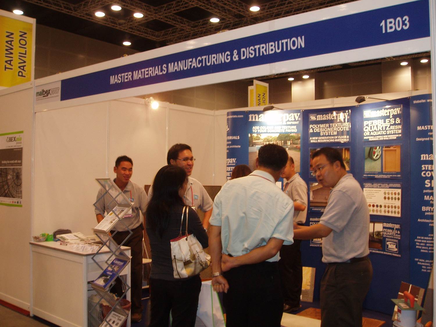 People at a trade show booth labeled