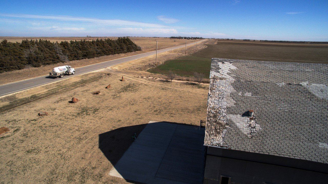 View from a building roof with a road and a semi-truck; rural landscape.