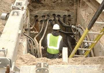 Worker Installing Power Cables Underground— Utility Needs in Piedmont, SC Worker Installing Power Cables Underground— Utility Needs in Piedmont, SC