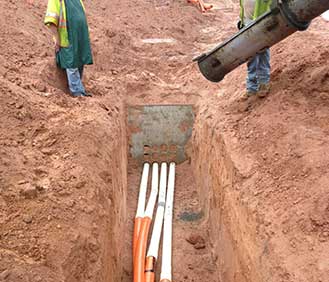 Workers Digging and Installing Pipes — Utility Needs in Piedmont, SC Workers Digging and Installing Pipes — Utility Needs in Piedmont, SC