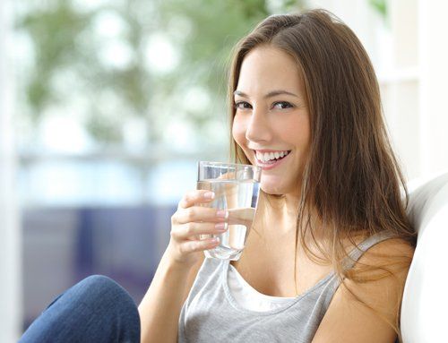 Purified Water — Girl Drinking Water at Home in Arroyo Grande, CA Purified Water — Girl Drinking Water at Home in Arroyo Grande, CA