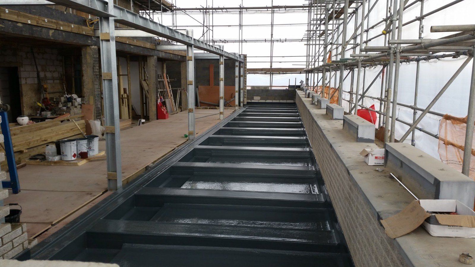 A building under construction with scaffolding on the side of it.