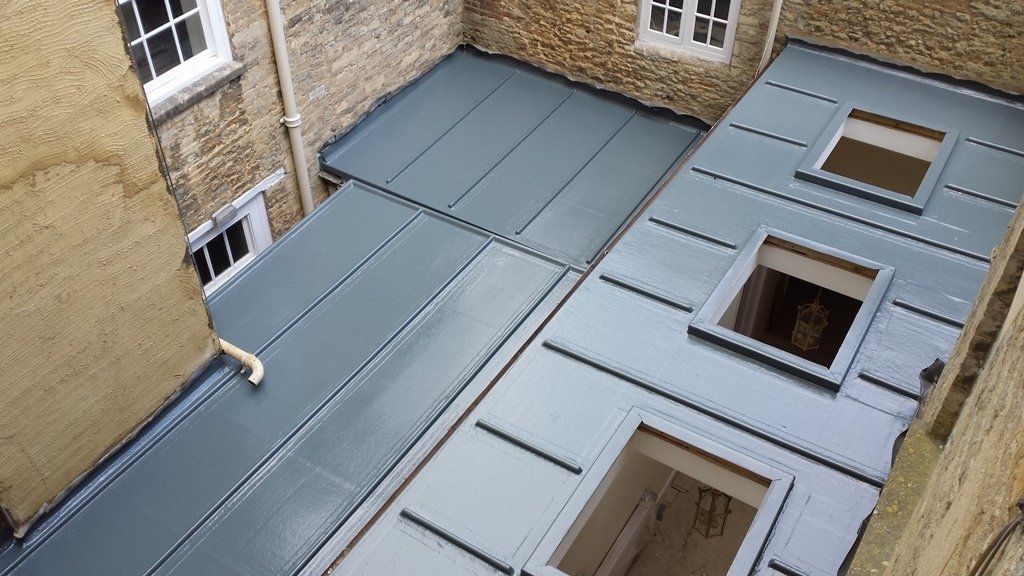 An aerial view of a building with a roof and windows
