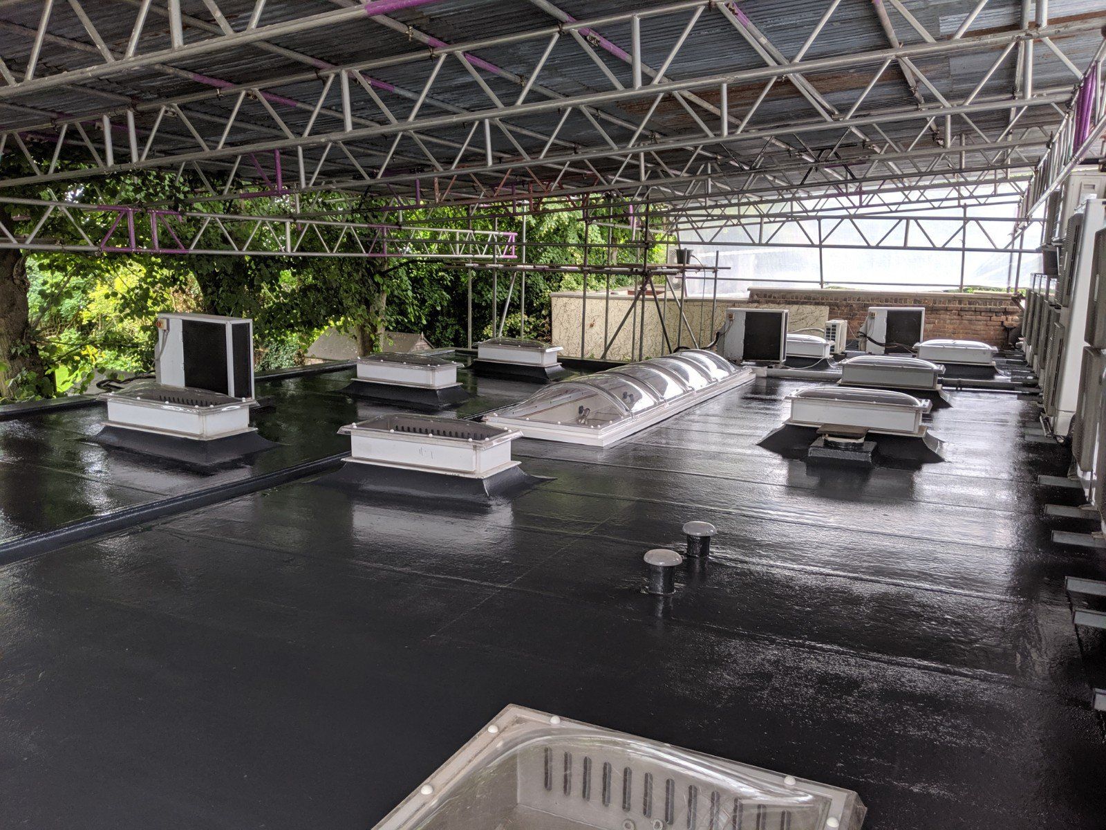 The roof of a building with a lot of air conditioners on it.