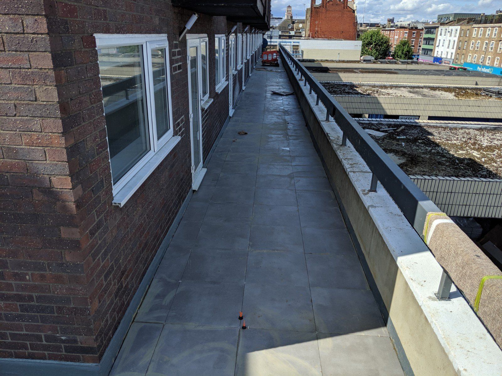 A brick building with a walkway leading to the roof