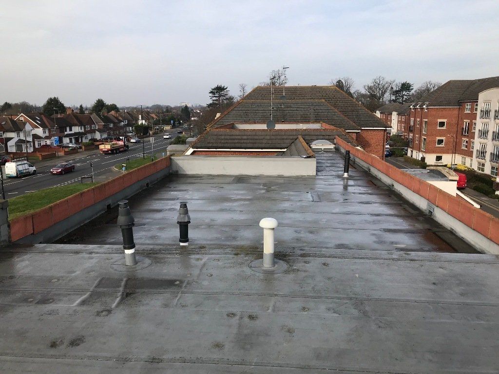 The roof of a building with a lot of pipes on it