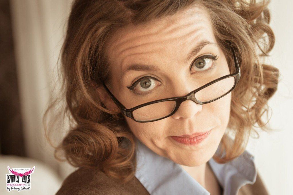 a woman wearing glasses is making a funny face
