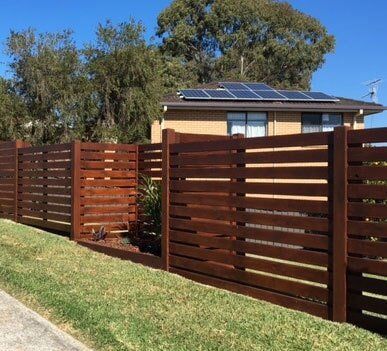 Wooden Fence with Curved on the Plants — Fencing in Port Macquarie, NSW