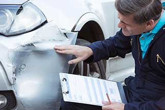 Mechanic Inspecting Car Damage - Auto Maintenance in Narragansett, RI Mechanic Inspecting Car Damage - Auto Maintenance in Narragansett, RI