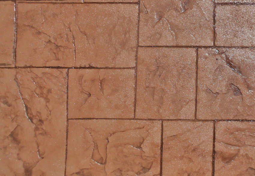 Close-up of brown stone or stamped concrete tiles with a textured pattern