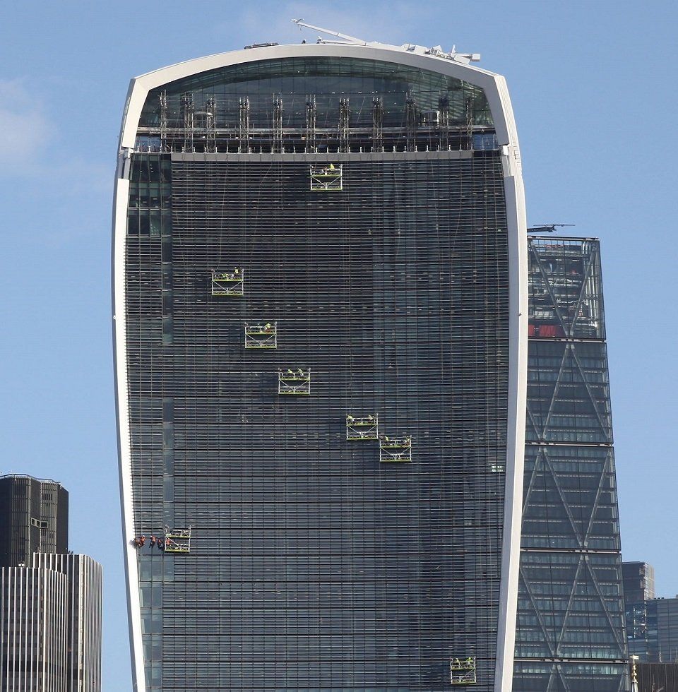 Double decked suspended cradles by Giraffe Access to provide access to fix light bouncing off of the Walkie Talkie building