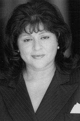 A black and white photo of a woman in a suit.