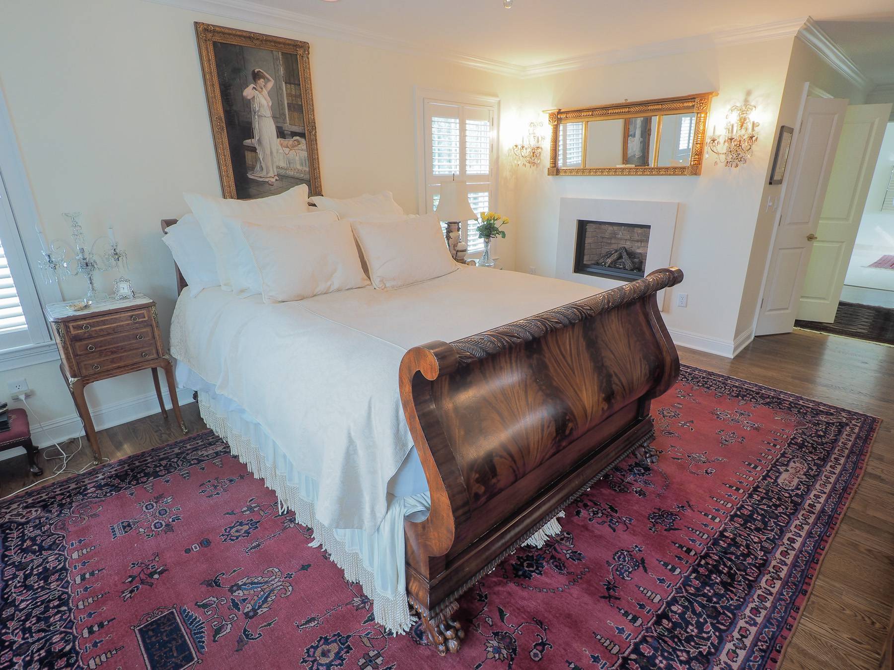 wooden bed on red rug