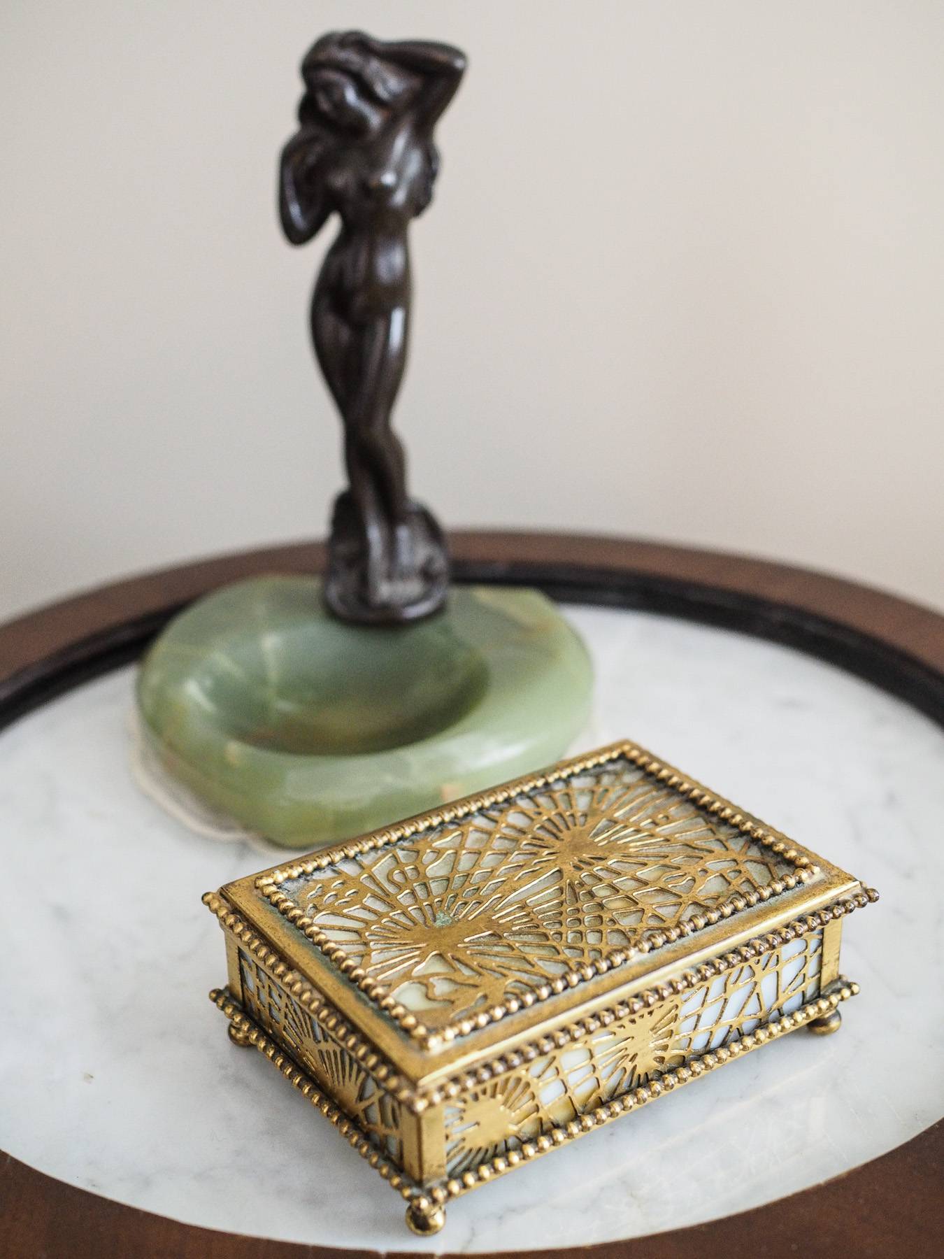side table with small chest and small statue