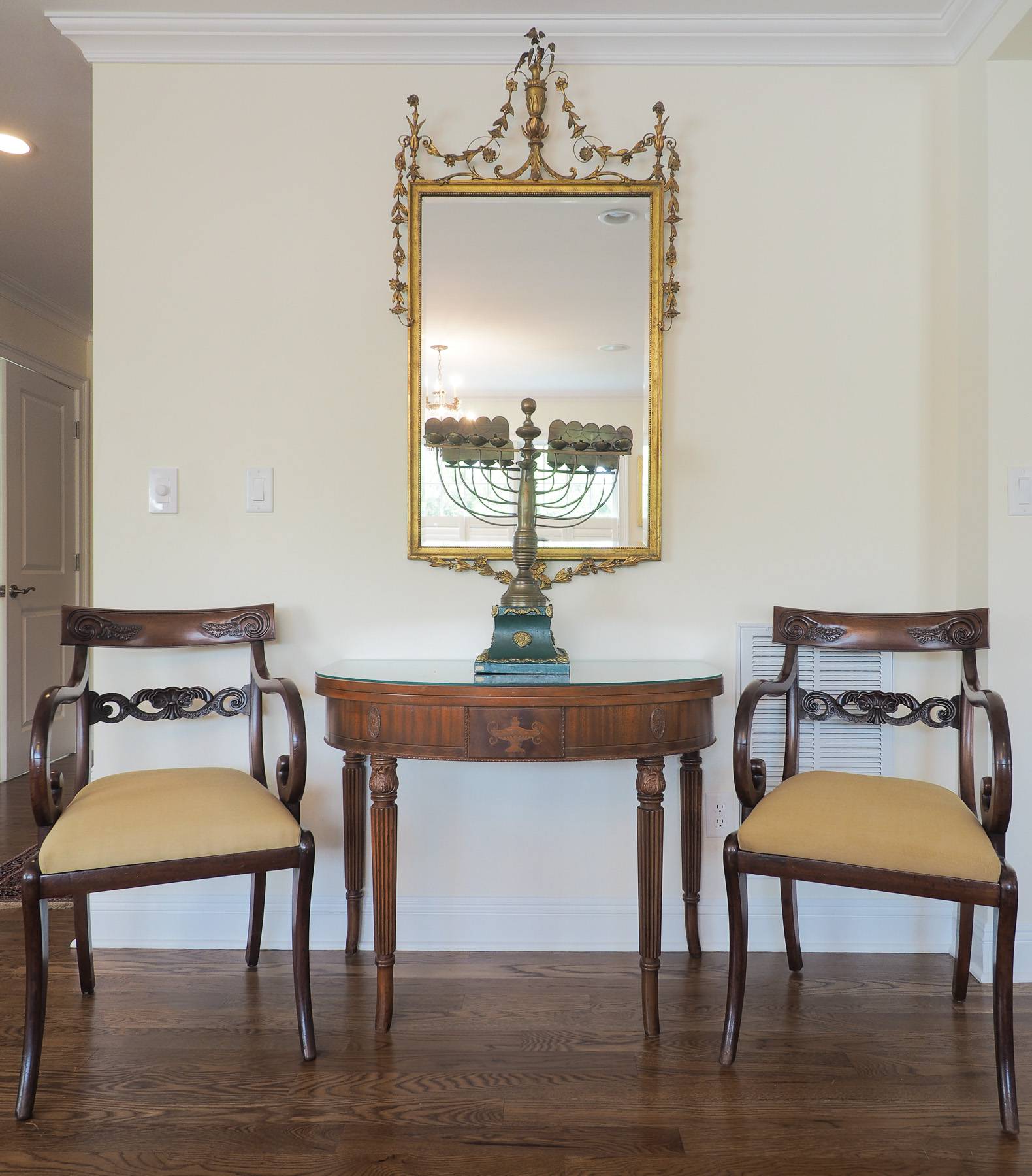 two chairs, a table, and a mirror