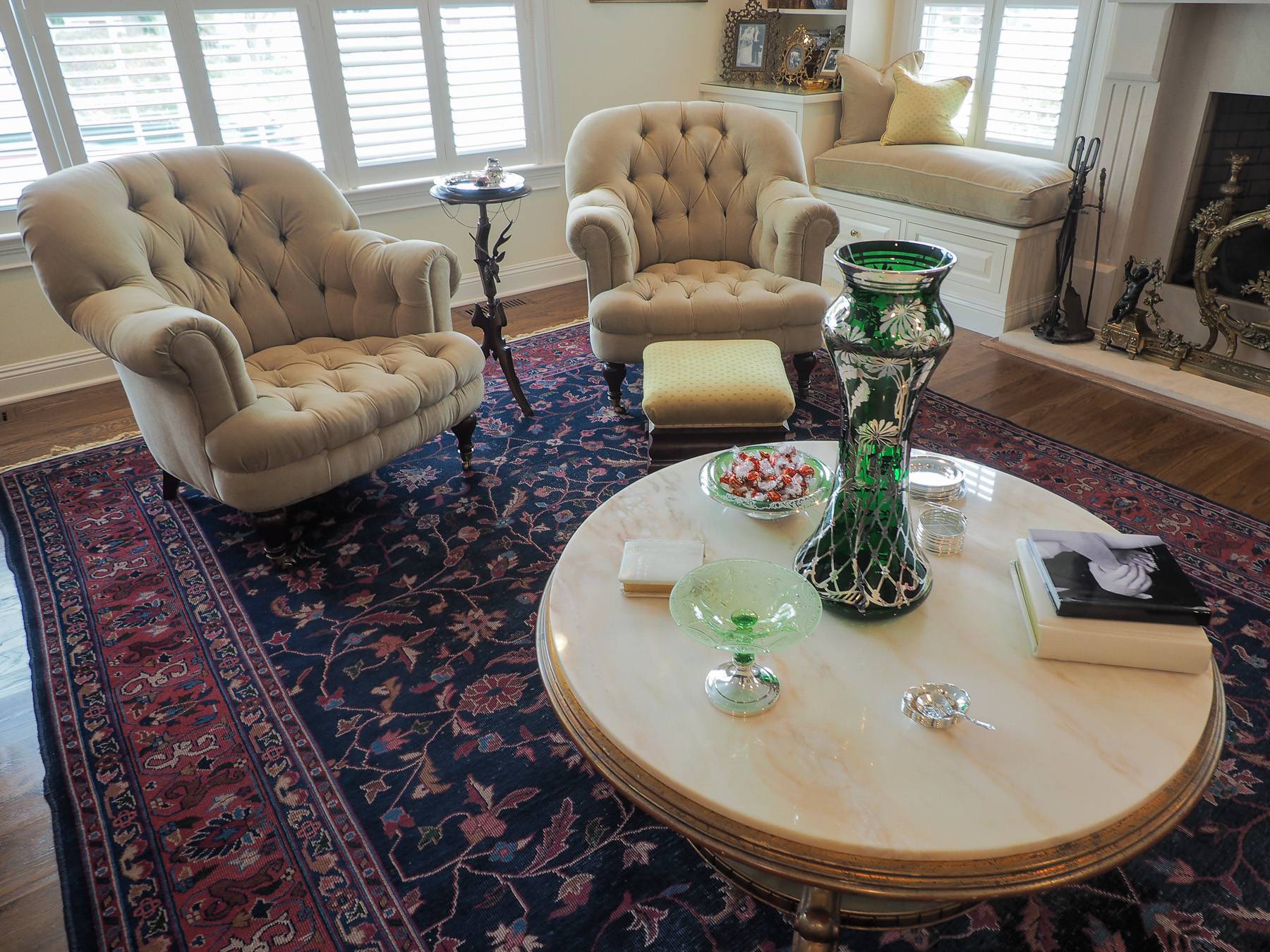 two fancy chairs and a table with decor on it