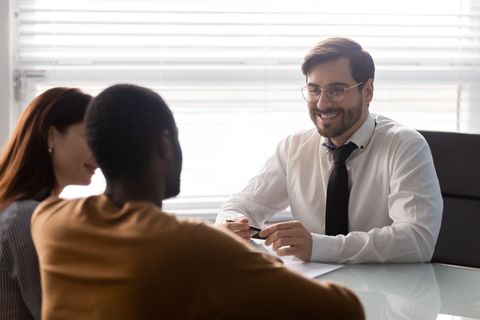 Attorney Talking To Young Couple — Ames, IA — Thornton & Coy, PLLC Attorney Talking To Young Couple — Ames, IA — Thornton & Coy, PLLC