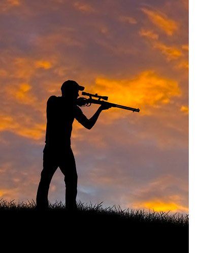 silhouette of hunter with rifle