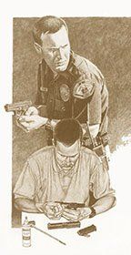 A police officer is standing over a man sitting at a table.