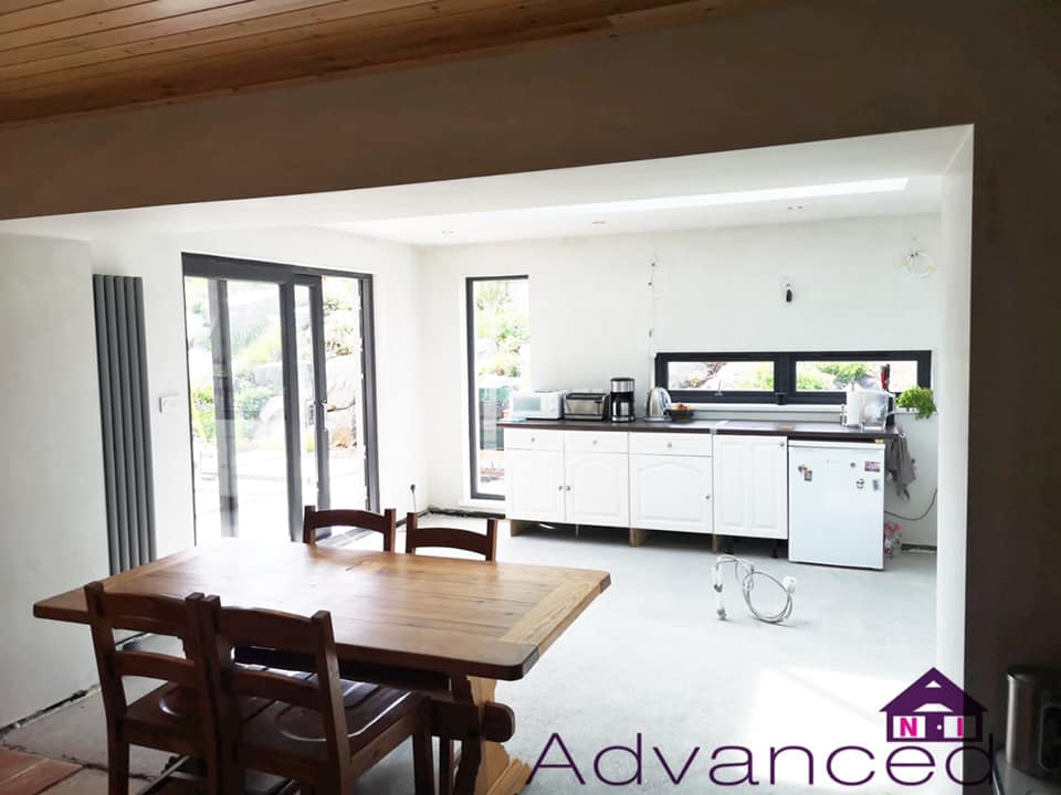 A kitchen with a table and chairs and a sign that says advanced