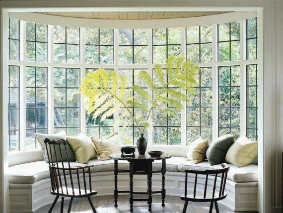 A bay window with a table and chairs in front of it