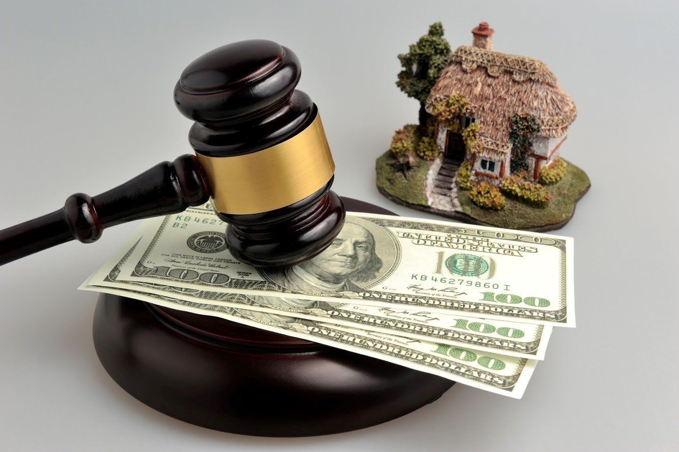A Judge's Gavel Is Sitting On Top Of A Pile Of Money — Cape Coral, FL — Dramko Diane Attorney At Law