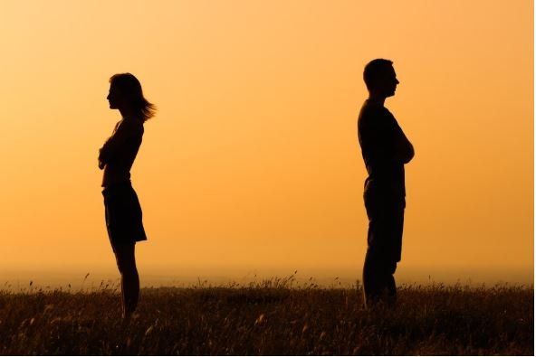 A Man And A Woman Are Standing Back To Back In A Field — Cape Coral, FL — Dramko Diane Attorney At L