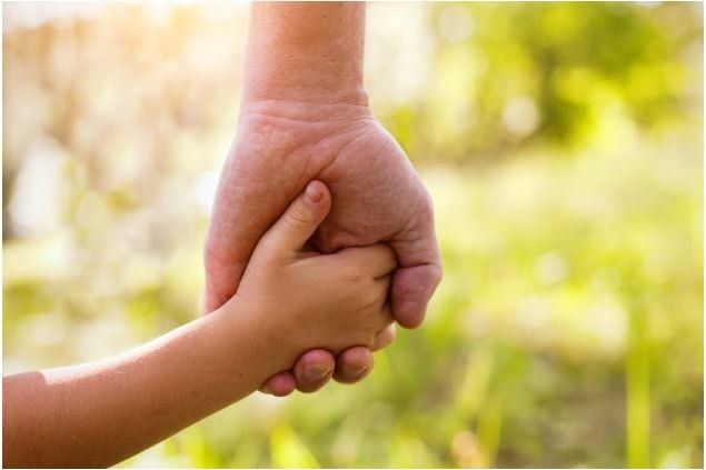 A Close Up Of A Person Holding A Child's Hand — Cape Coral, FL — Dramko Diane Attorney At Law