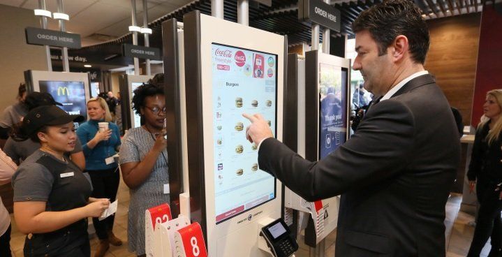 Kiosk ordering is being used by more fast food franchises to reduce waiting lines and labor costs McDonalds is using kiosk ordering to reduce labour costs