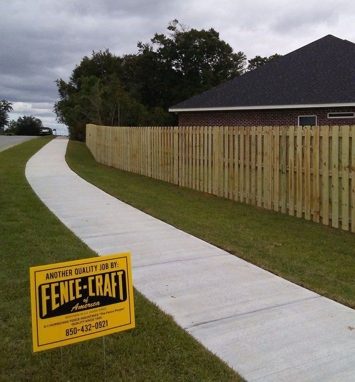 Business Sign and Wood Fence Beside the Sidewalk — Pensacola, FL — A1 Hurricane Fence Business Sign and Wood Fence Beside the Sidewalk — Pensacola, FL — A1 Hurricane Fence