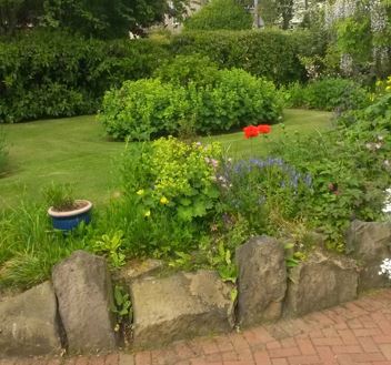 mature gardens with low stone border wall