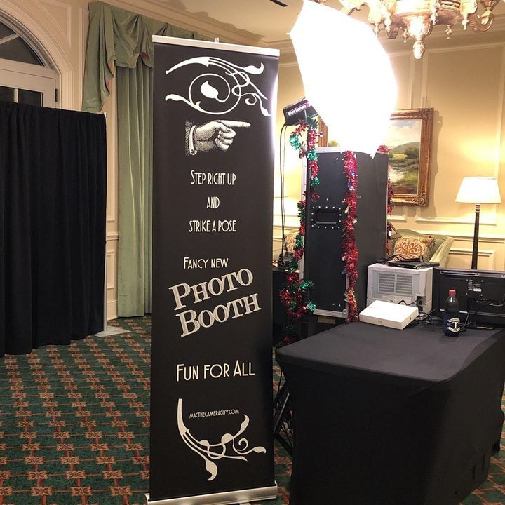 A photo booth with a sign that says photo booth fun for all