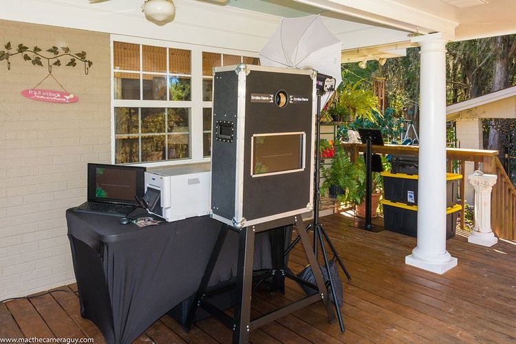 A photo booth is sitting on top of a wooden deck.