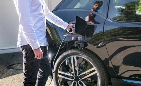 Man charging electric car
