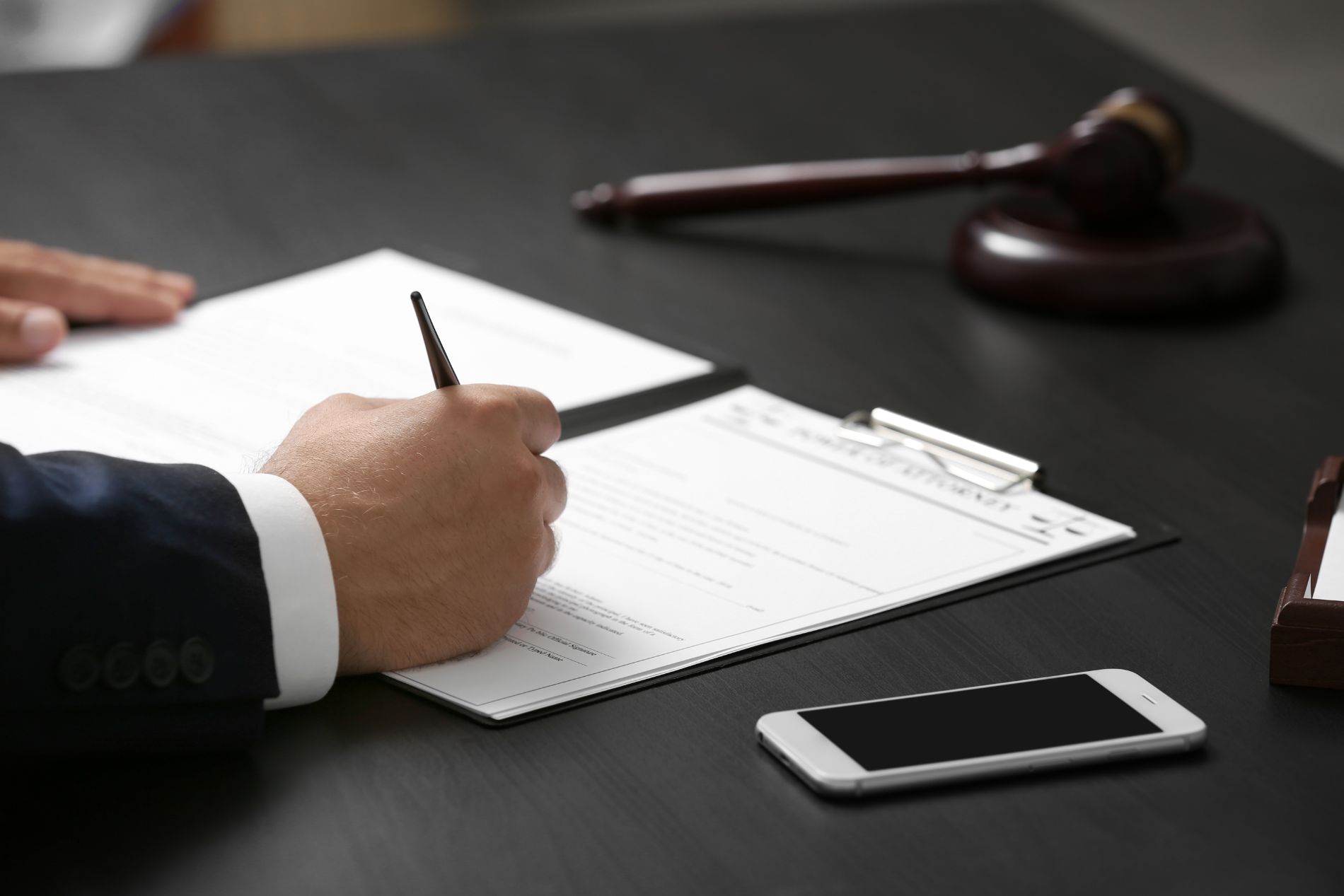Man with pen signing papers