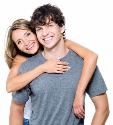 young smiling couple woman standing behind man in grey shirt