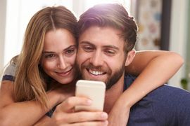 couple making call young couple looking at smart phone