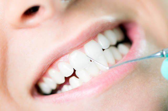 cleaning teeth cleaning teeth with scraper