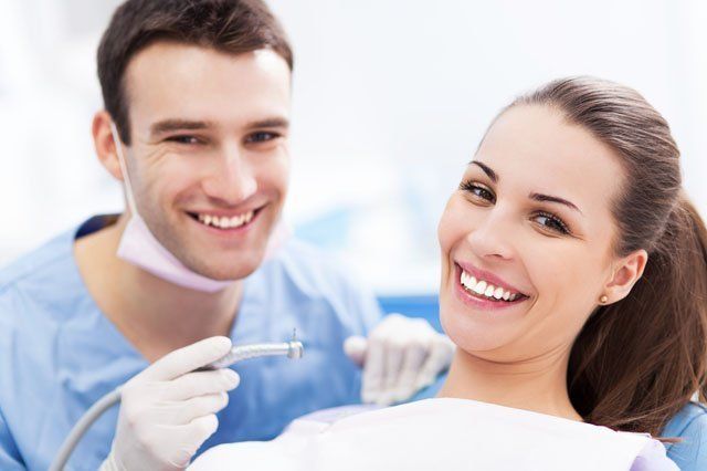 dentist with female patient young male dentist with female patient