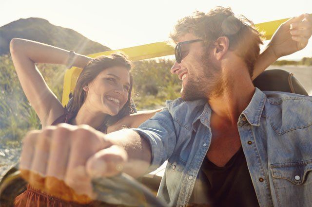 couple in convertible car happy young couple in convertible car in sun
