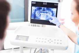 looking at tooth x-rays dentist and patient looking at tooth x-rays