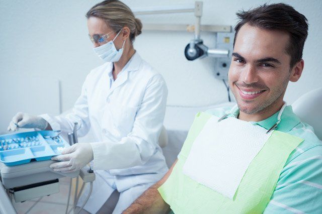smiling young male patient wait for dental treatment
