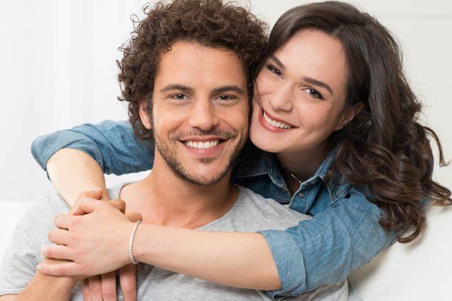 young couple happy young couple on lounge woman standing behind