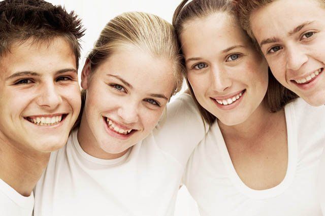 young smiling children young smiling teens dressed in white