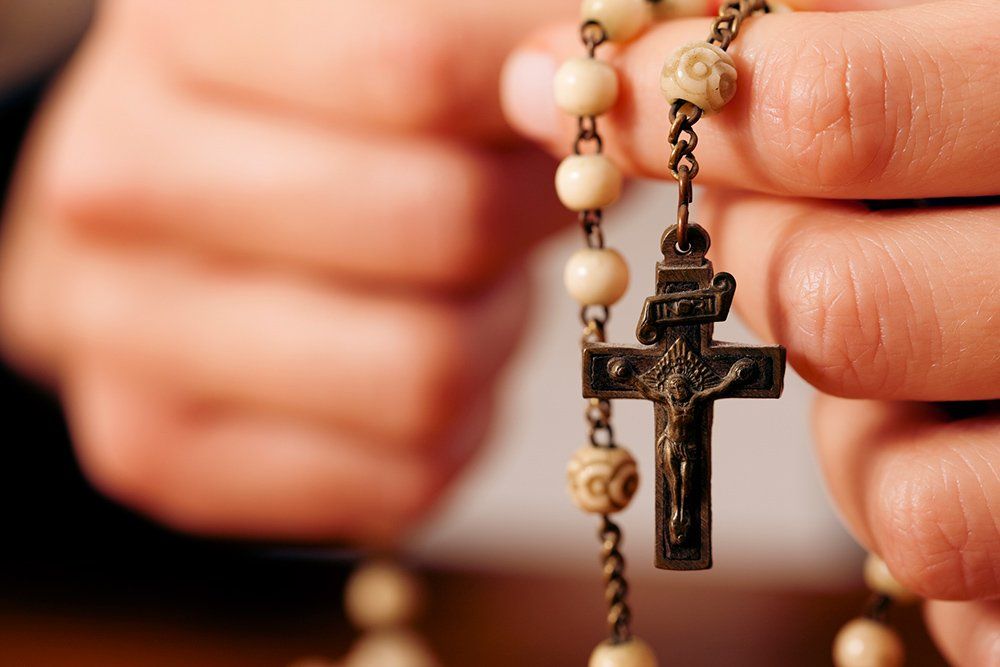Woman Praying with Rosary — Saint John, IN — Boric Religious Gift