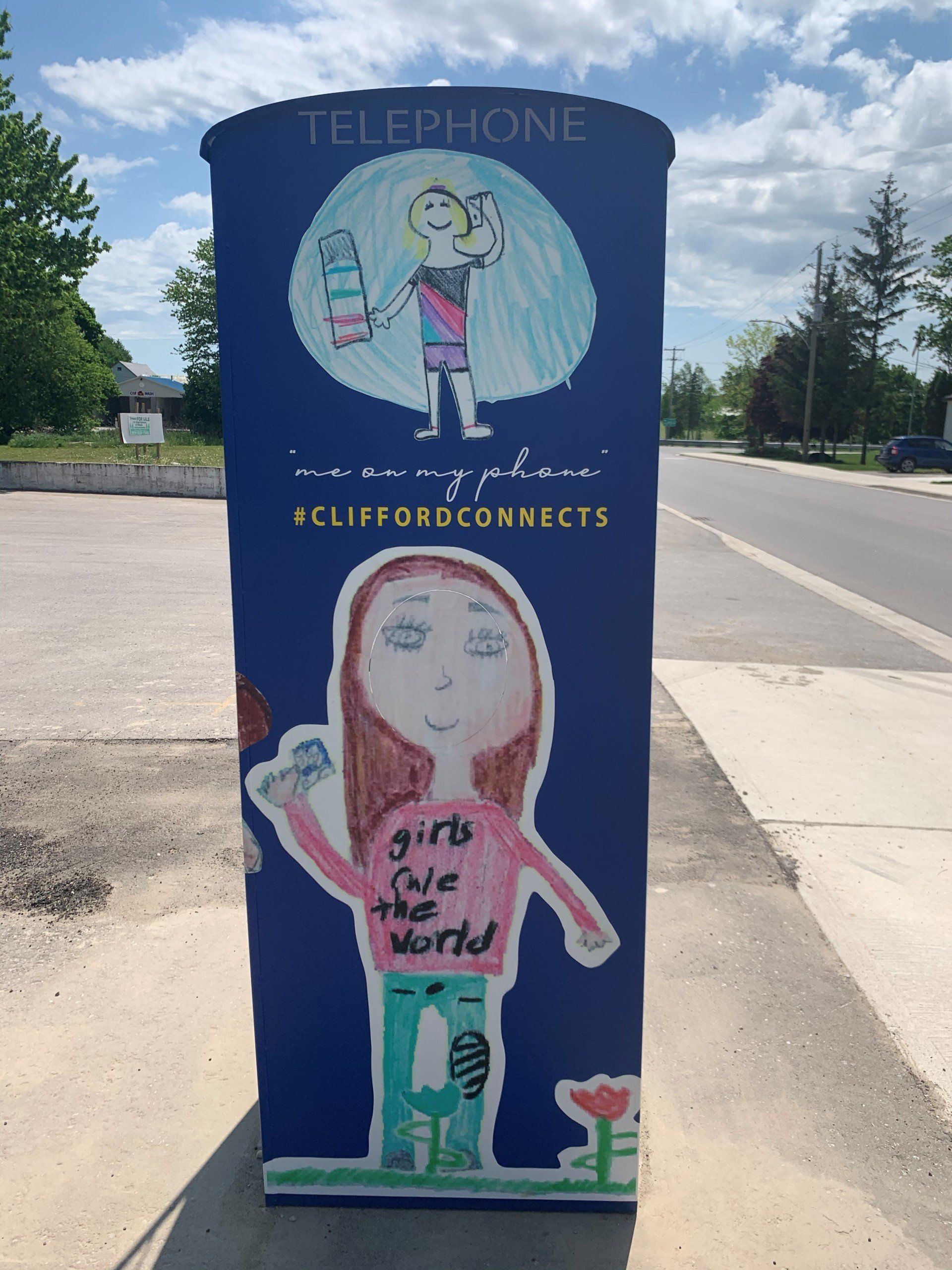 This booth was made for talking” mural – interactive art installation - blue booth back with kids' art