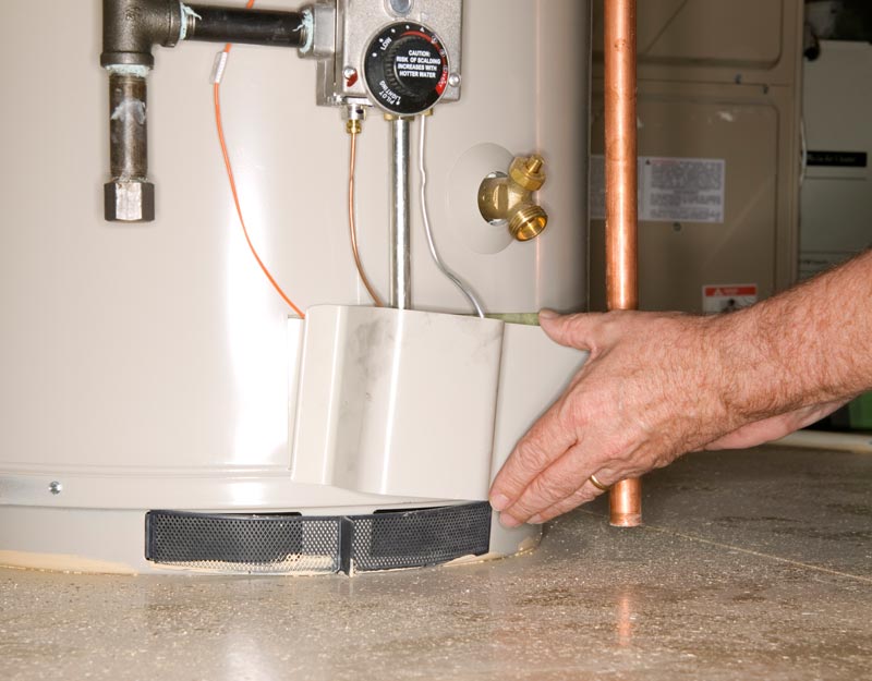 Man checking water heater Man checking water heater